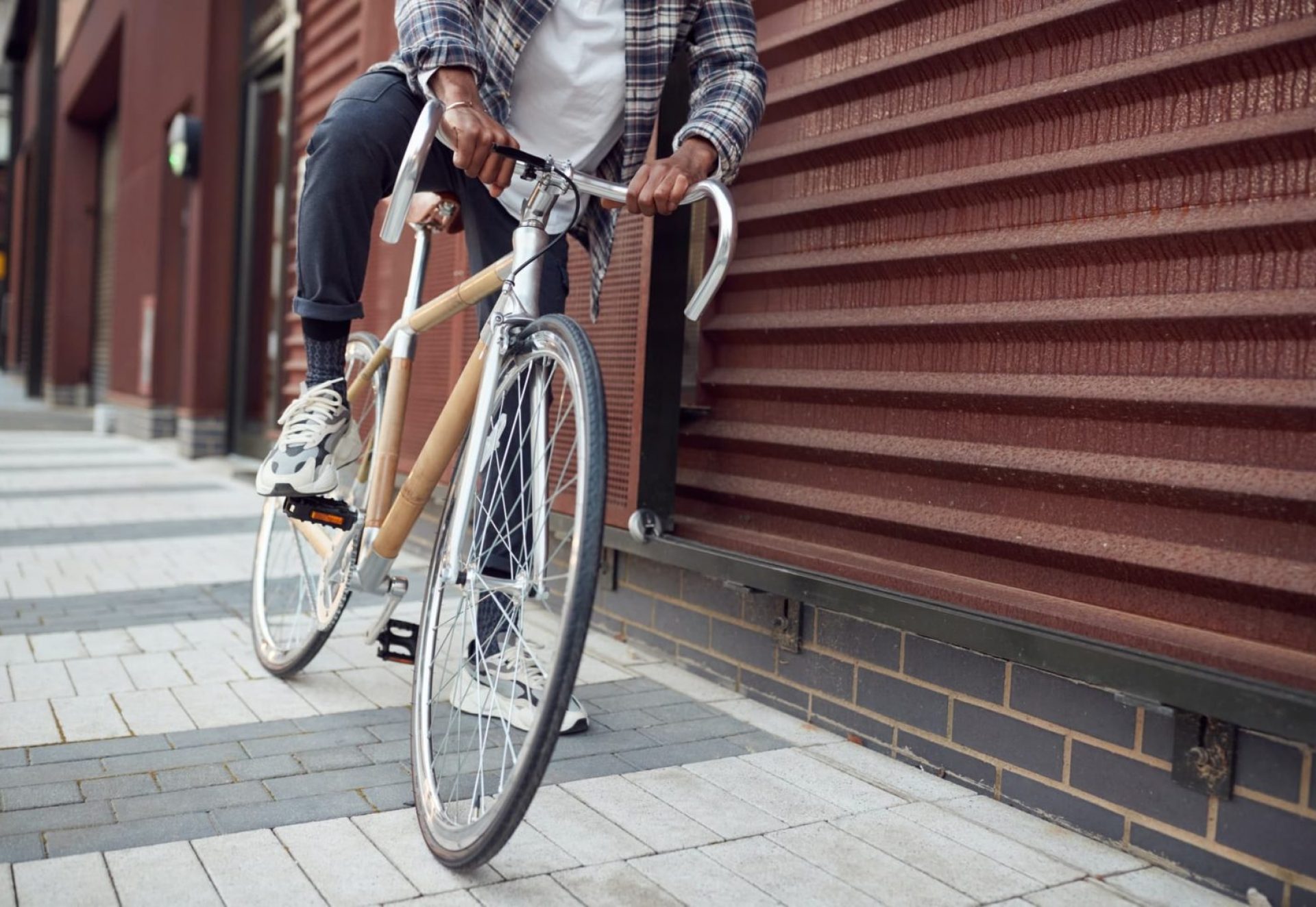 Close Up Of Man Riding Sustainable Bamboo Bicycle On City Street