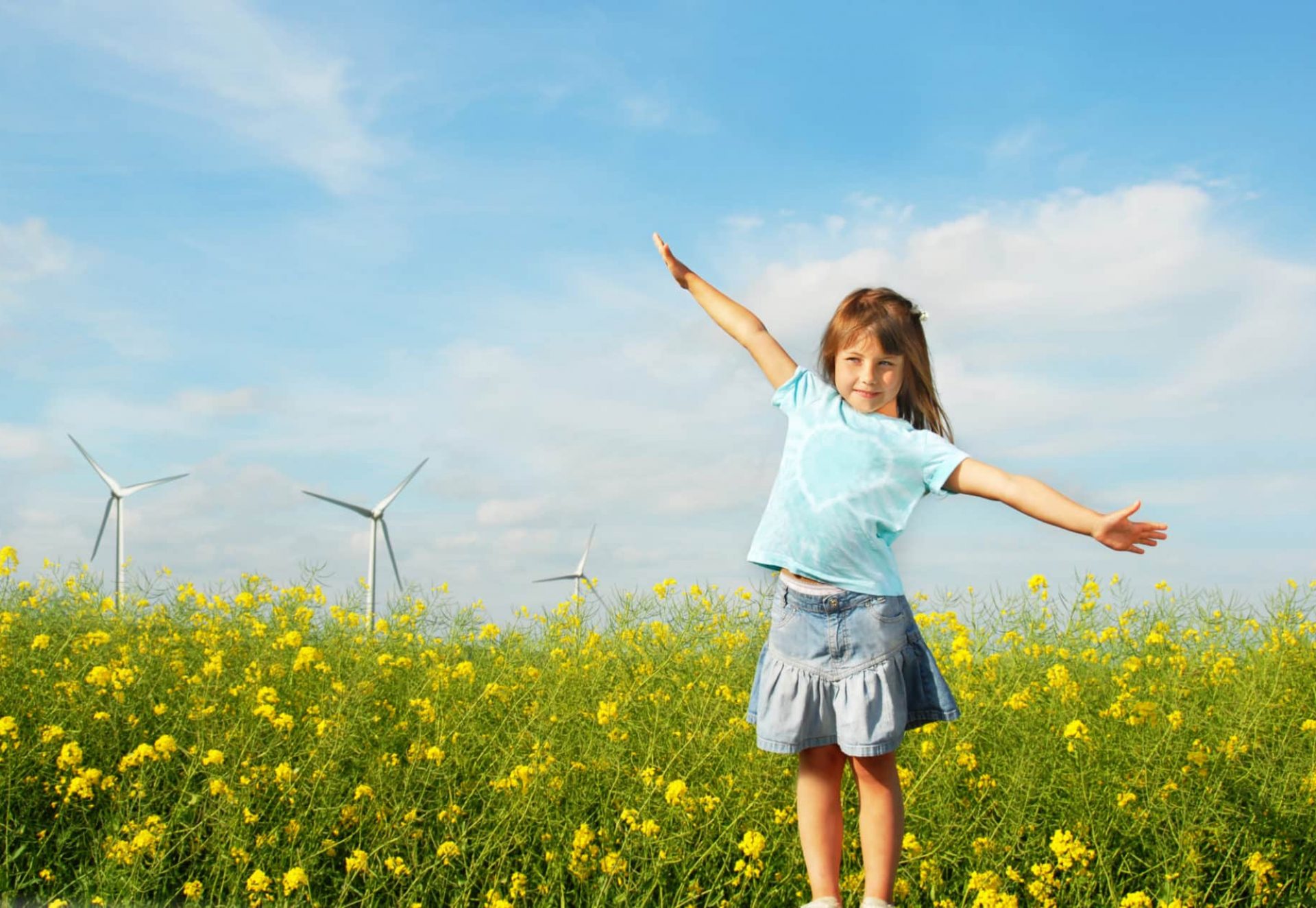 Little,Girl,In,Front,Of,Windmills